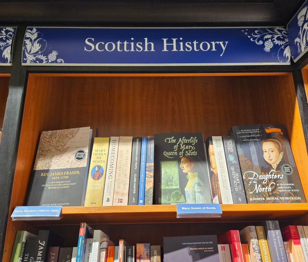 A bookshelf in a bookshop showing my book on James Fraser alongside multiple works on Mary, Queen of Scots.