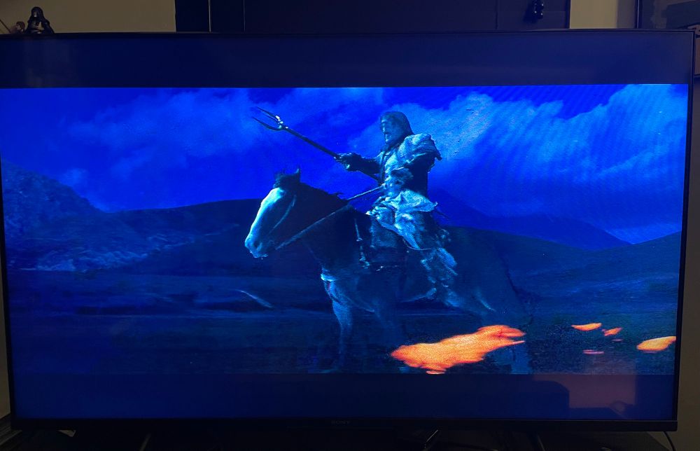 A cyclops brandishing a spear and riding across the desert on a firemare, its hooves aflame with speed.