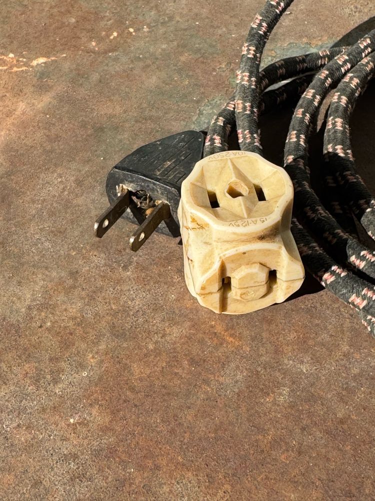 Archaic, non-polarized extension cord. These were phased out starting in 1962.