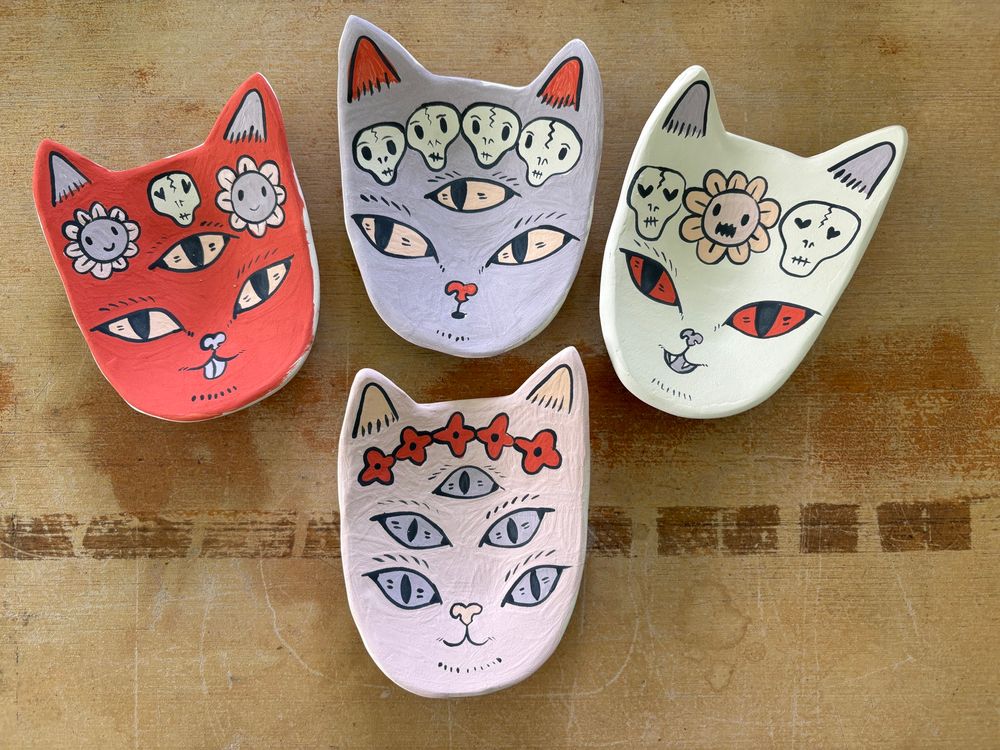 Cat trinket dishes fresh from the bisque kiln waiting for glaze. 