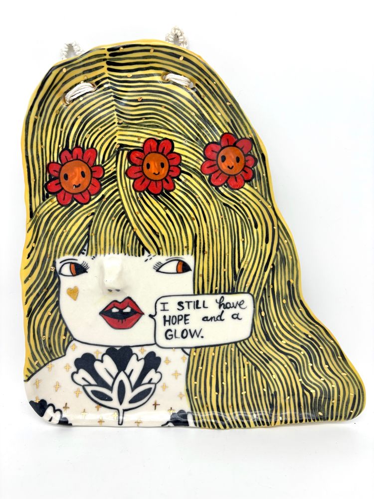 Hand painted porcelain plate of a blonde woman with a flower crown saying: I still have hope and a glow