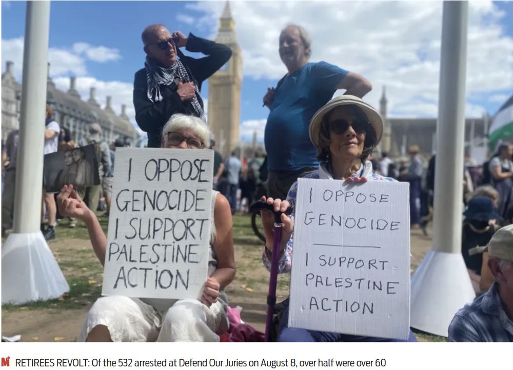 Photo of two Lewisham 'grannies' at the Defend Our Juries event with placards readings "I oppose genocide, I support Palestine Action'