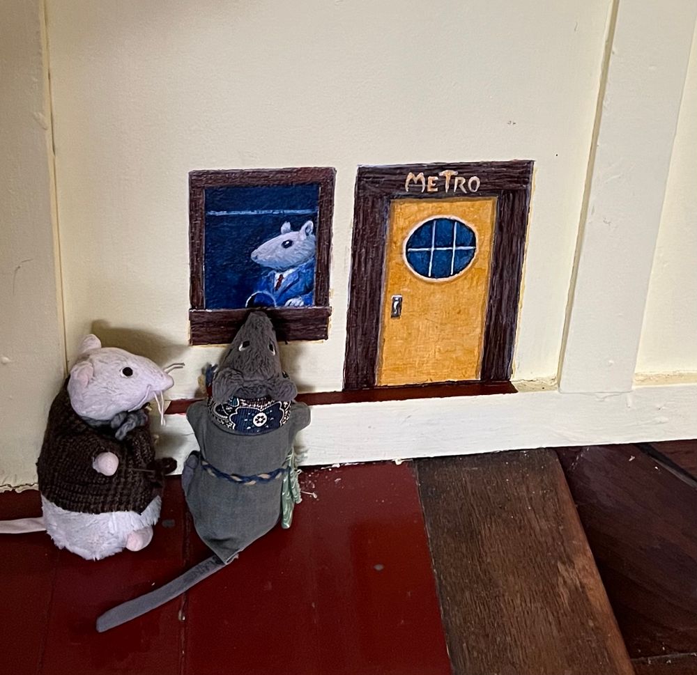 Photo of two plush mice buying tickets at a painted Metro ticket booth