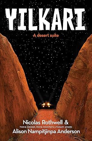 Red-orange cliff-faces rise up on the left and right hand side of the cover, with a red dirt road running between them. The space between the cliffs is filled with black sky and a multitude of stars. At the end of the road, facing the viewer, is a car, with its headlights on high beam.