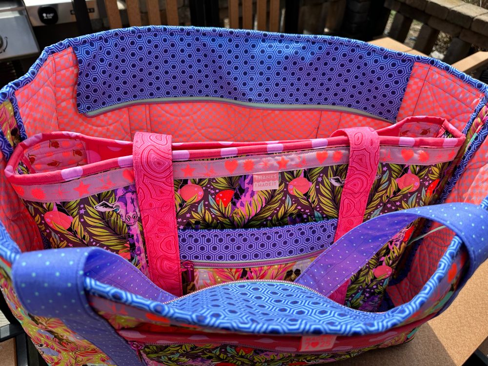 The large tote fits inside the XL Tote, with lots of room to spare. 
