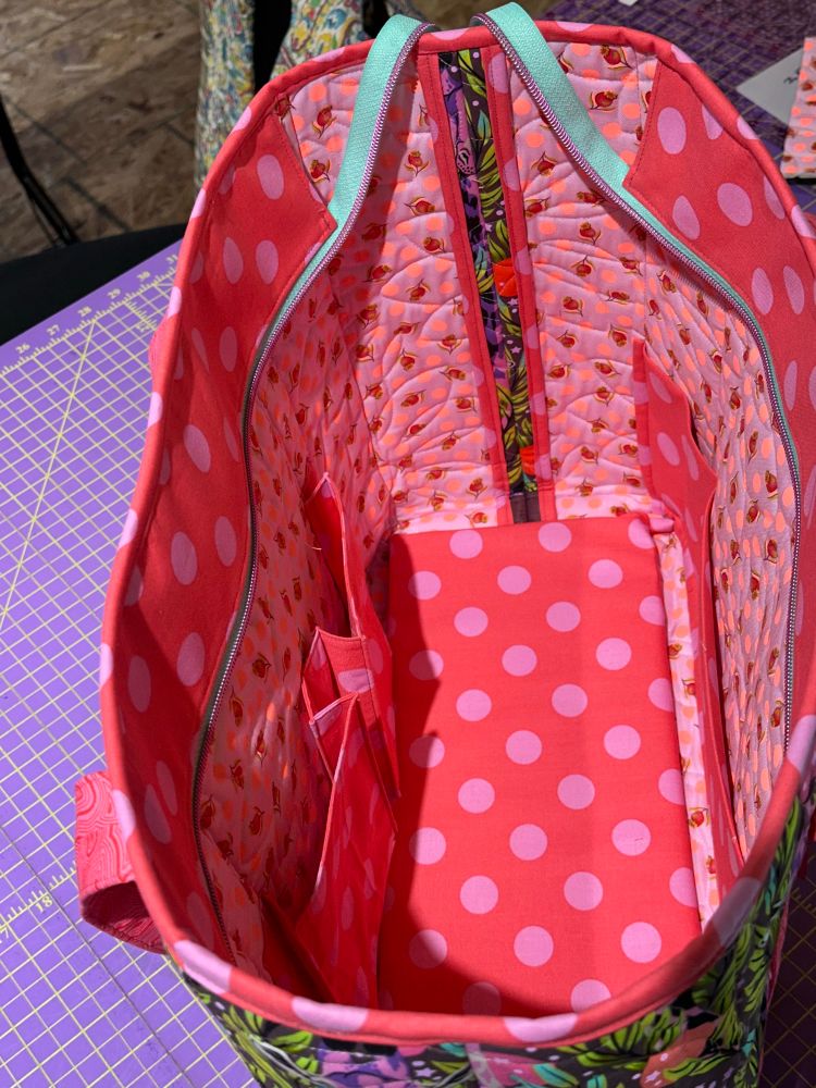Inside of tote, with 2 bellowed pockets on one side and a full width divided pocket on the other. 