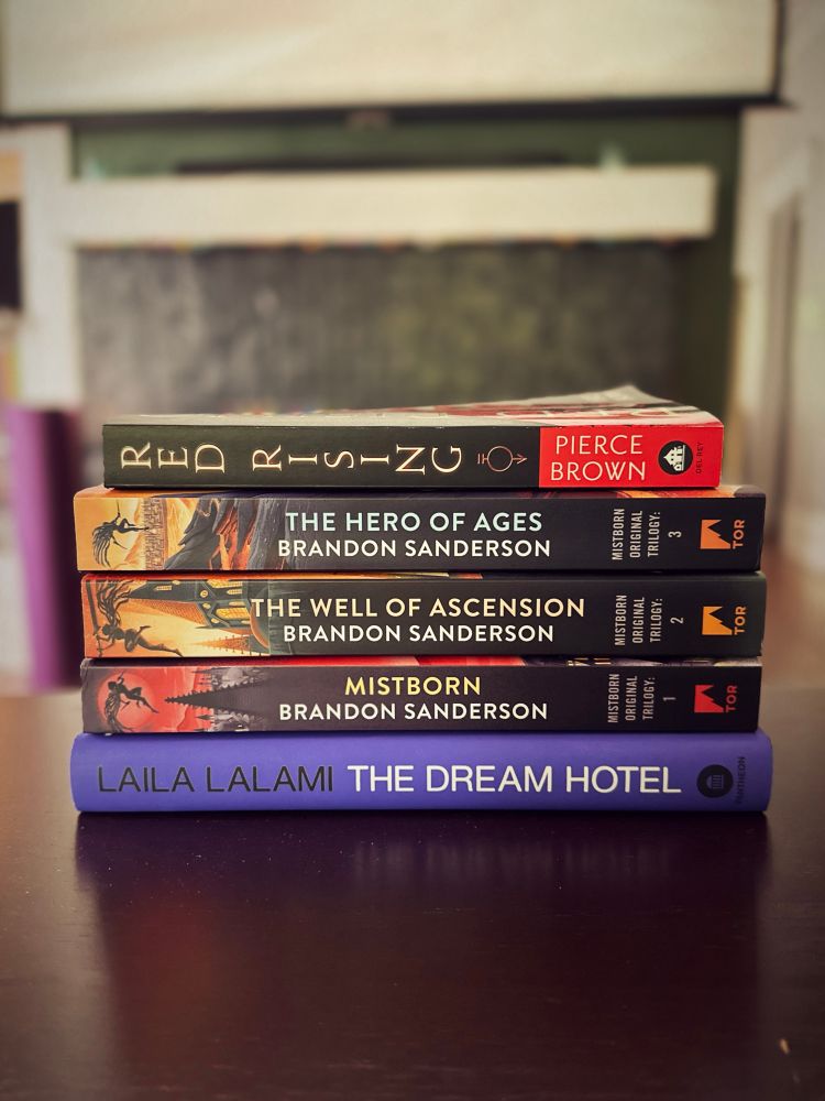 A picture of five books bought on independent bookstore day. The dream hotel, the mistborn trilogy, and red rising. 