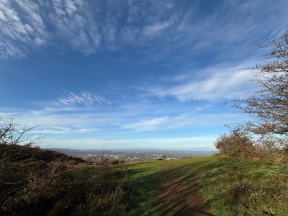 Photo of the view from the top of a hill down to the town below