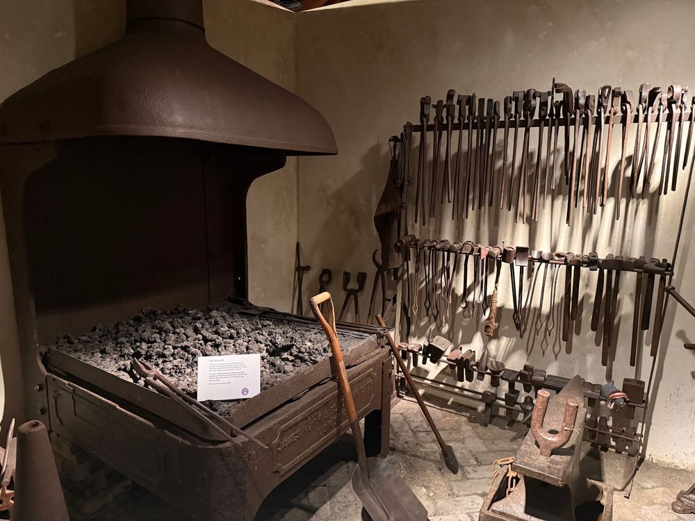 A blacksmith forge and tools that are part of an exhibition at the Museum of London Docklands. 