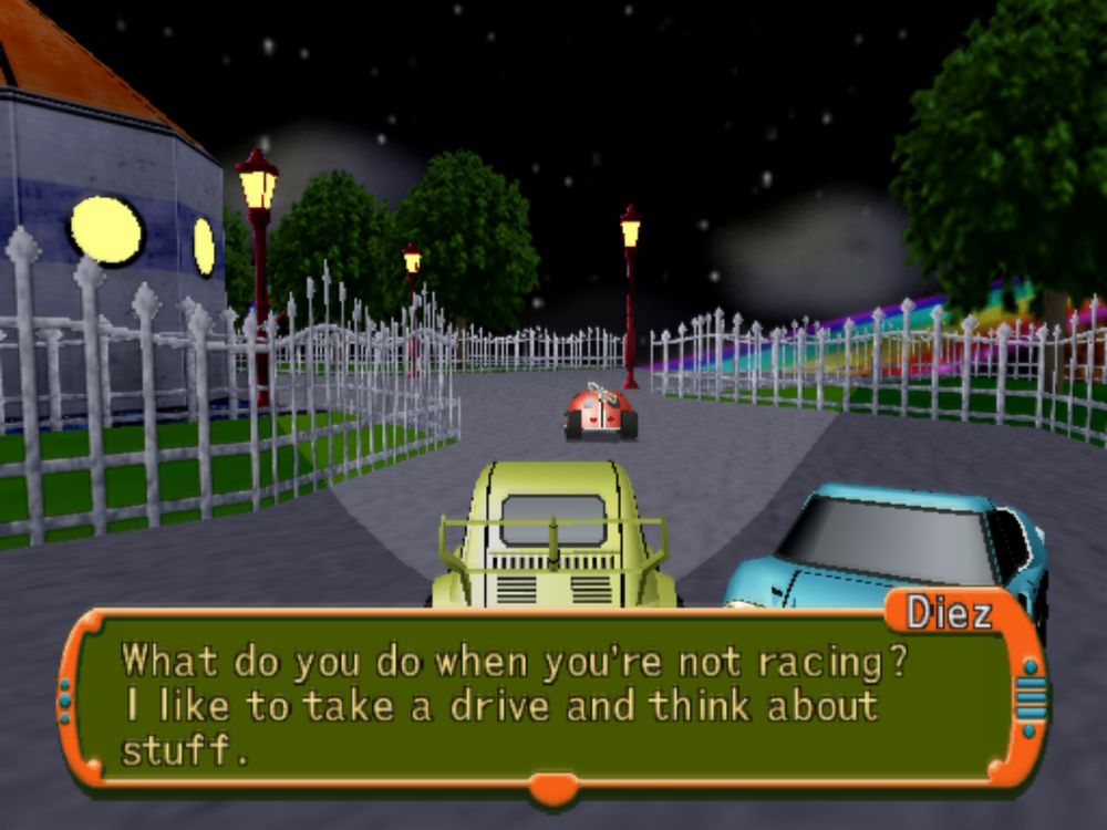 Screenshot of Road Trip Adventure, showing my yellow Fiat 500 driving around a nighttime town, with white fences around the road and a rainbow in the distance. A blue car is next to me and says "What do you do when you're not racing? I like to take a drive and think about stuff."