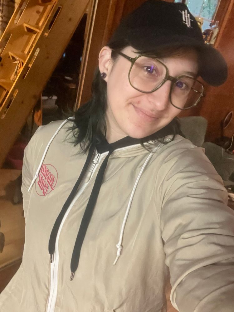 A selfie, I’m wearing a black Buttress hat, a Santa Cruz jacket over a black sweatshirt