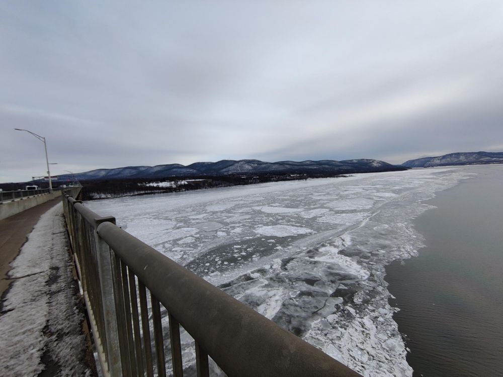 Hudson River from the Hamilton Fish Bridge. Ice near the east bank, looking east toward Beacon with Mt Beacon and the Hudson highlands in the background.