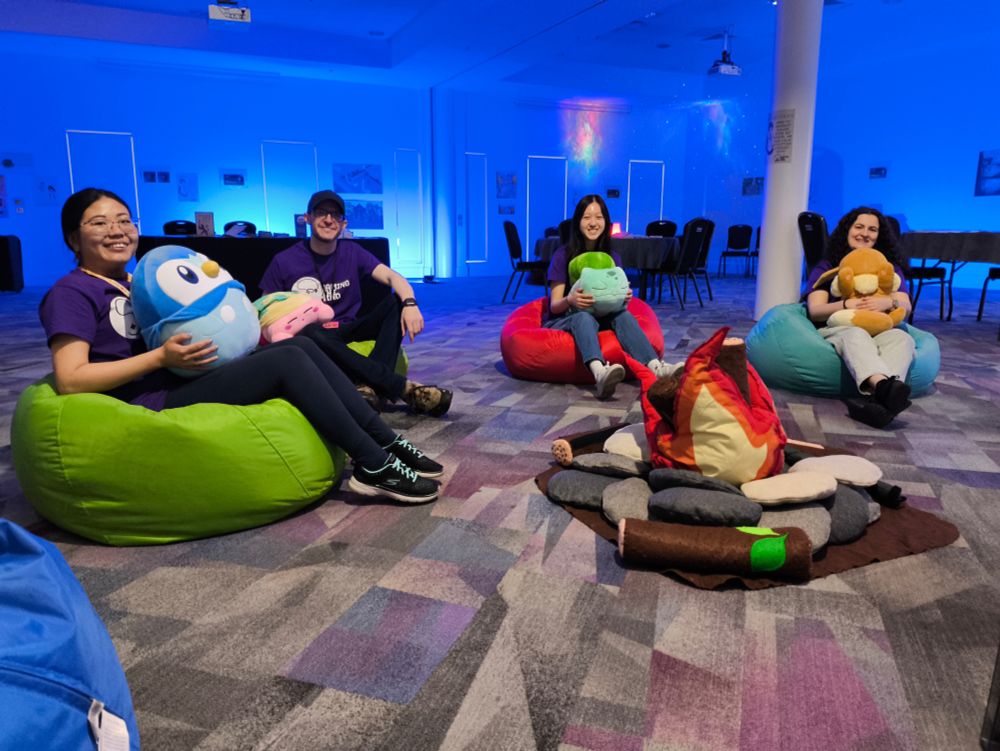 Reset Room volunteers sitting in quiet room around plush bonfire