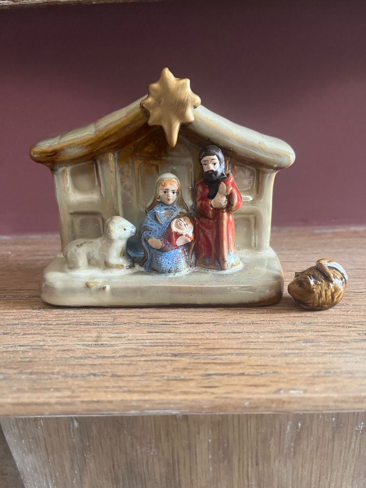 A small brown mouse by a manger 