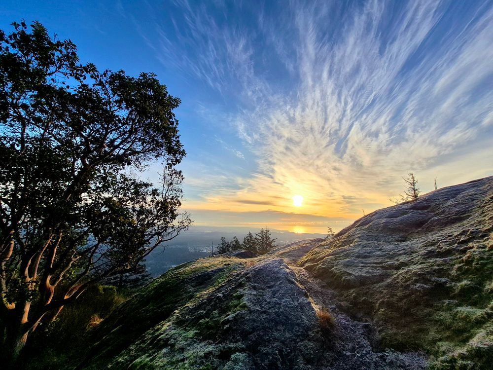 A mountaintop sunrise looking out towards the Pacific Ocean.