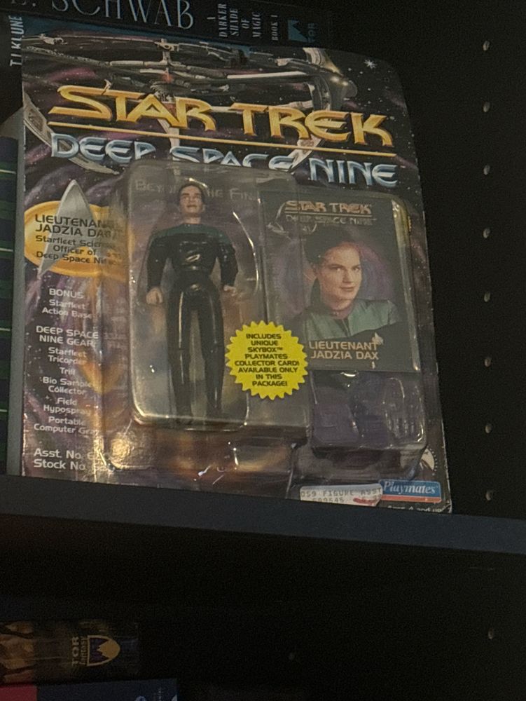 A sealed Star Trek Deep Space 9 action figure and trading card of Lieutenant Jadzia Dax