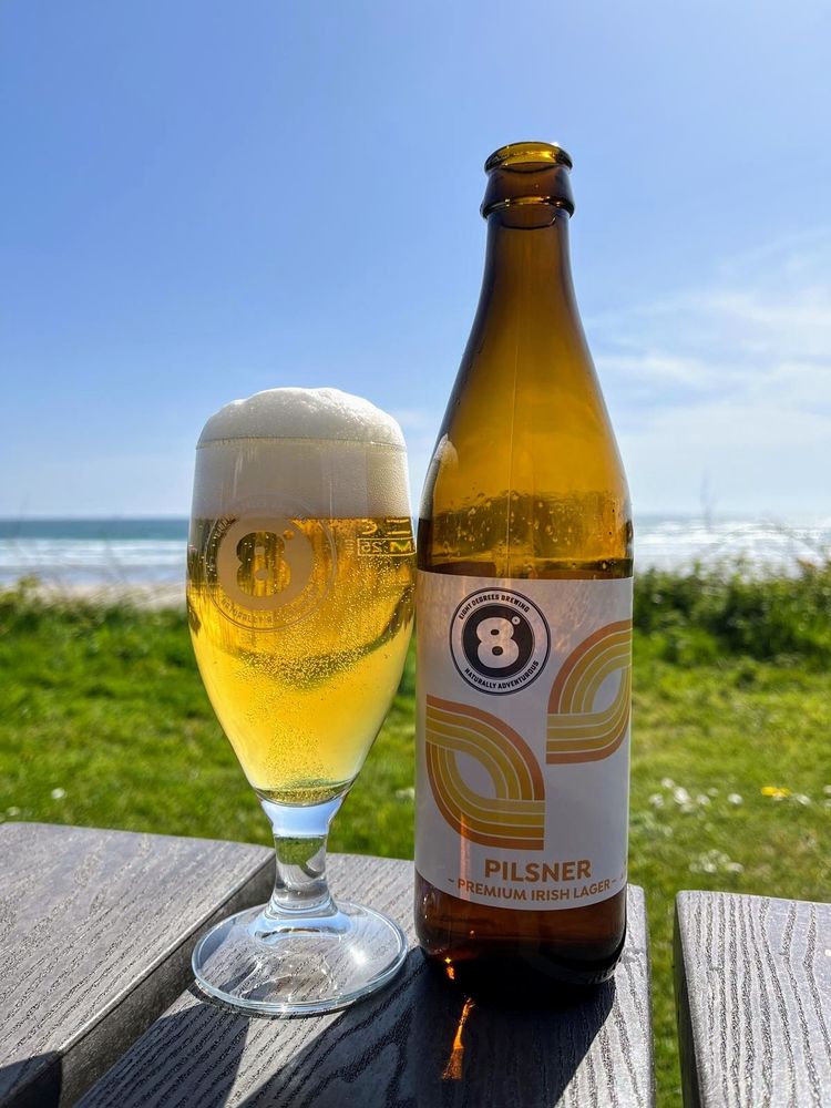 A glass of Eight Degrees Brewing premium Irish Pilsner 