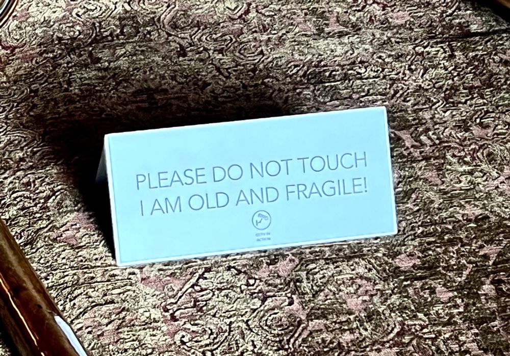 Sign reading “Please do not touch, I am old and fragile”.