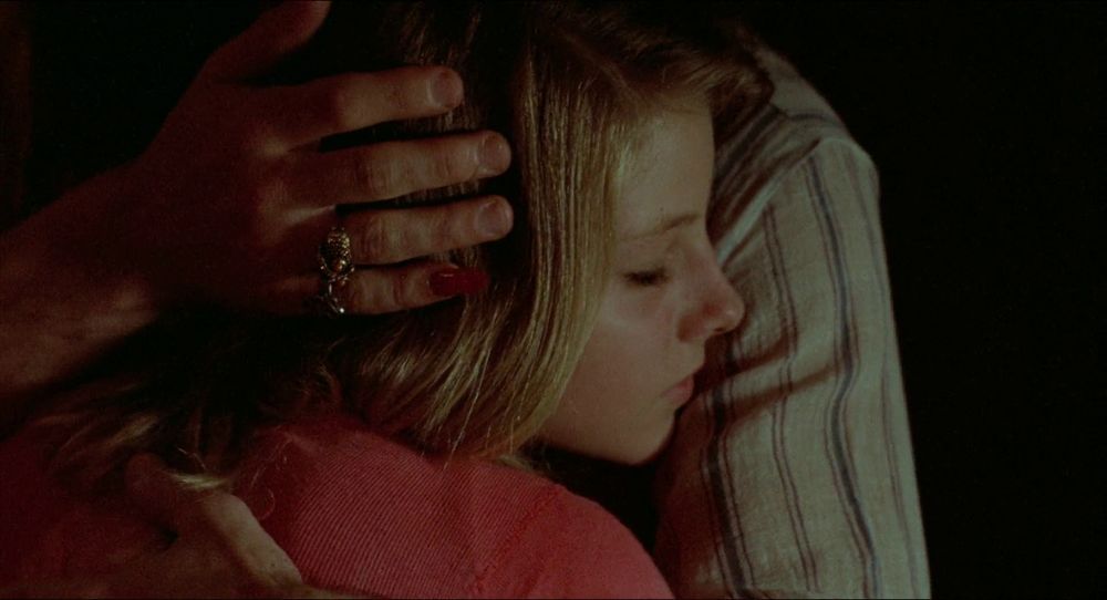 TAXI DRIVER: Sport holding Iris' head, his last two fingers joined in a gaudy ring, his pinky finger long and painted red