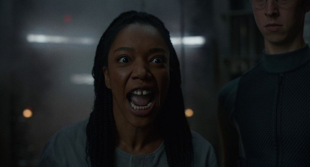 Naomi Ackie as Nasha Barridge in Mickey 17, in the scene where she yells at the Trump-like character