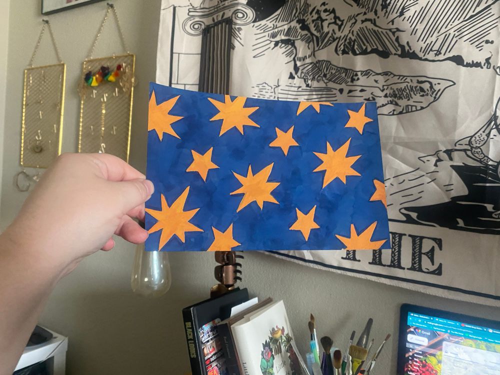 A gouche painting of yellow star shapes on a dark blue background 