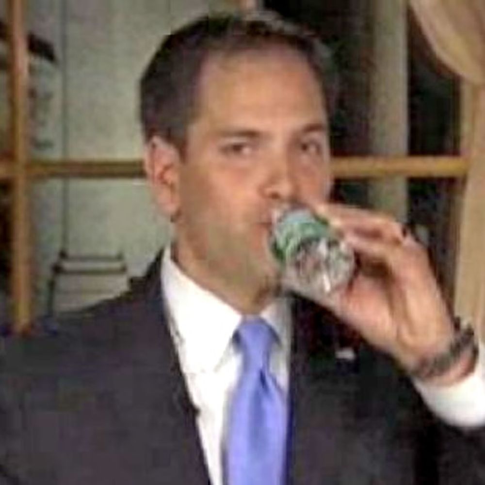 Rubio drinking a bottle of water during a national TV address. 
