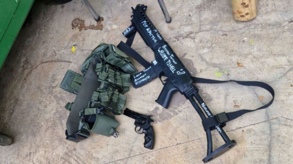 Things written include: For Agartha (mythical neo nazi land), 1198 (year of when crusaders won the siege of Acre), Welcome to Hell, Brenton Tarrant (Christchurch Mosque shooter), Natural Selection (at the end of the gun), A drawing of the symbol of the Iron Guard (Romanian fascist movement), Alexandre Bissonnette (another mosque shooter but in Quebec), Luca Traini (Migrant shooter in italy), 14 words, and a symbol of the Latvian SS