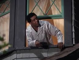 Black man leaning outside of his window telling people to shut up. (John Weatherspoon in House Party).