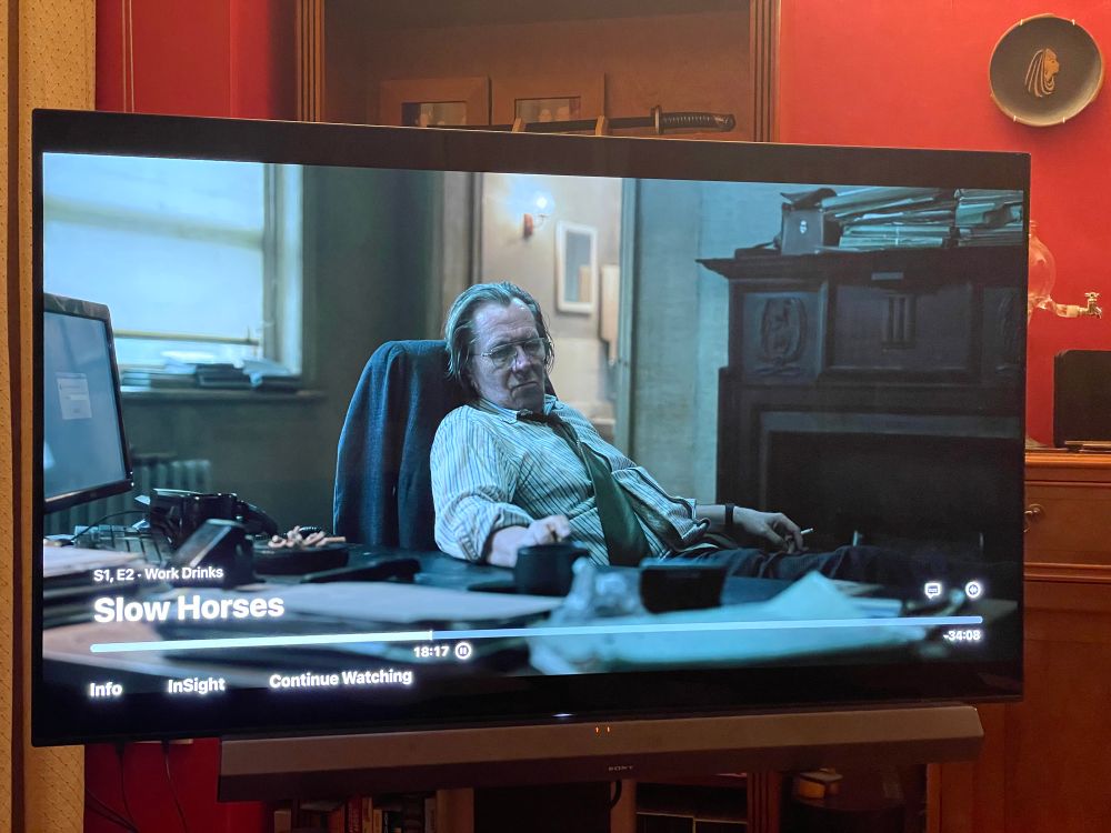 Gary Oldman in Slow Horses sitting at his desk