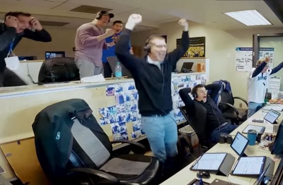 The Mariner's broadcasting crew reacting to Geno's grand slam. Fist pumping and mouths wide with shock and joy.