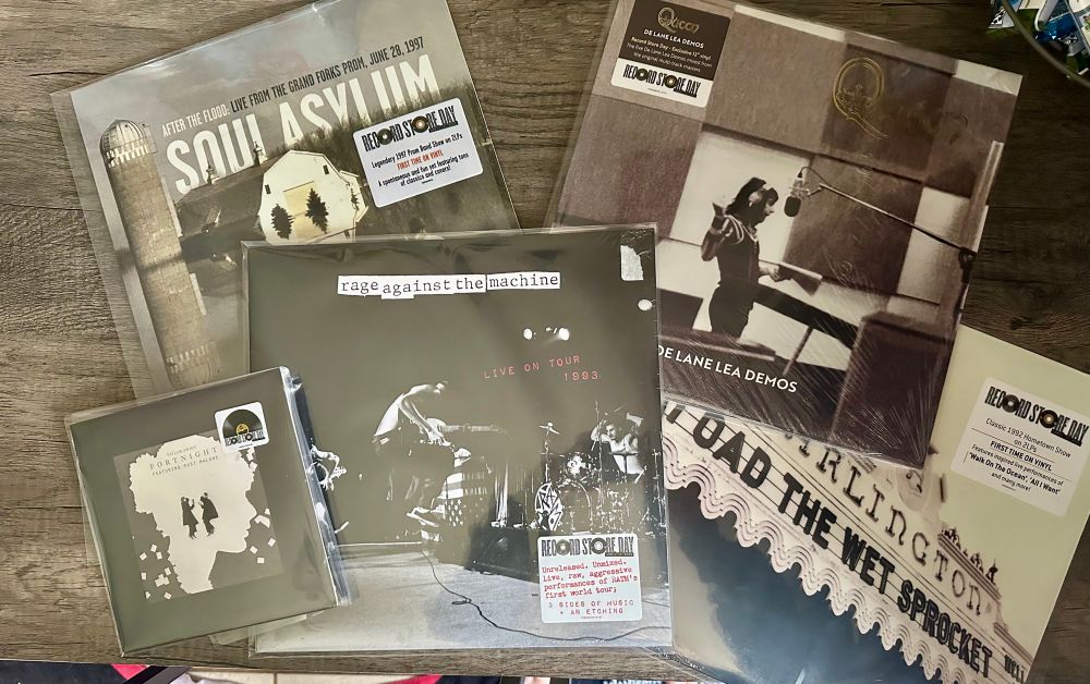5 record albums:  left to right - Taylor swift / post Malone collab, soul asylum, rage against the machine, queen, road the wet sprocket 