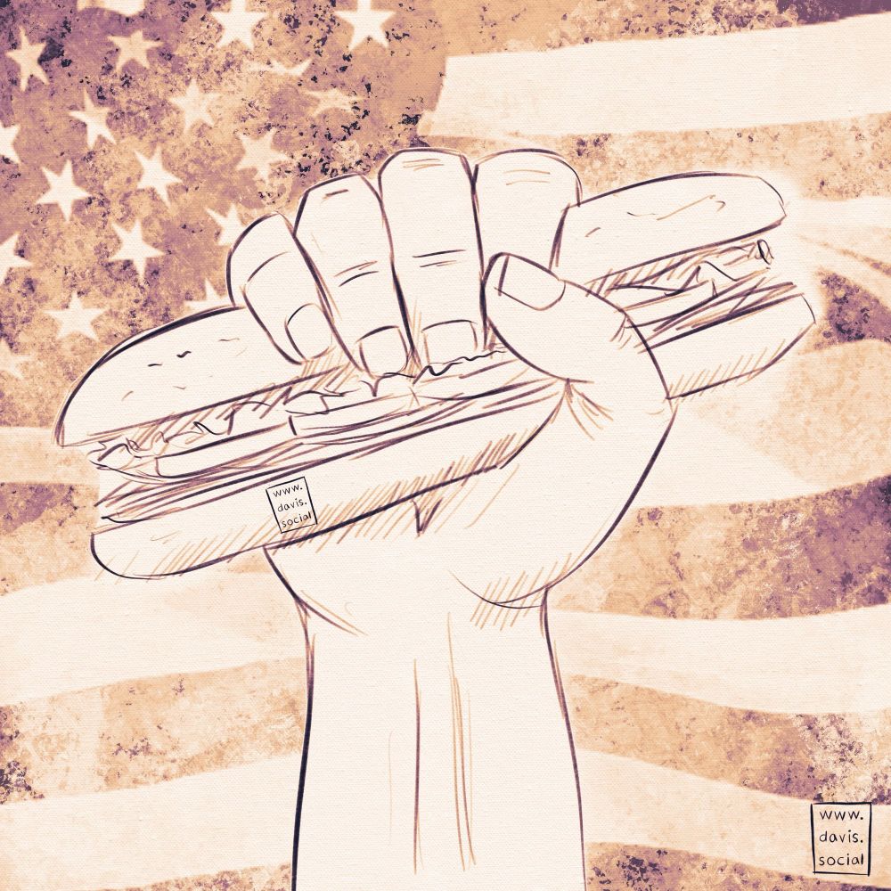 A hand clenching a foot long sandwich in defiance with an American flag in the background 