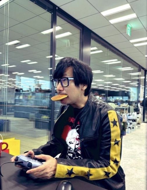 hideo kojima gaming with a pancake in his mouth