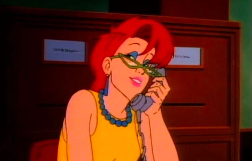 Red headed woman with glasses on the phone, smiling.