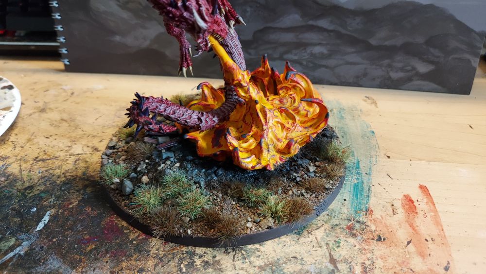 Fire breathing red dragon, close up on the scorch marks on the base