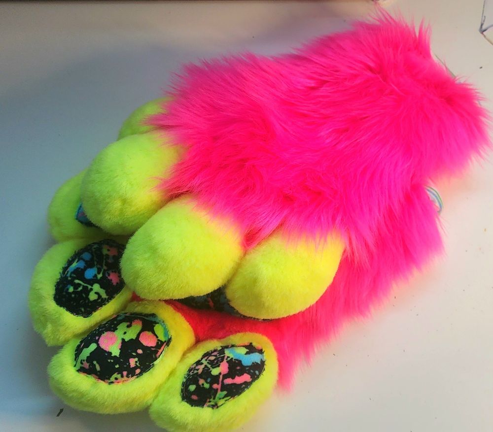 Neon yellow and neon pink handpaws with blacklight paint splatter paw pads