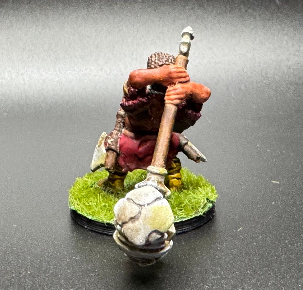 The same halfling from behind, emphasizing his stone greathammer