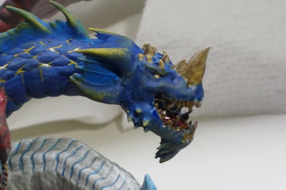 View of the left side of the blue (lightning) head. It is primarily blue with yellow accents suggesting the crackling of electricity