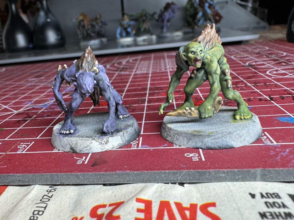Front view of two small full minis. One has purple skin and the other a sickly green