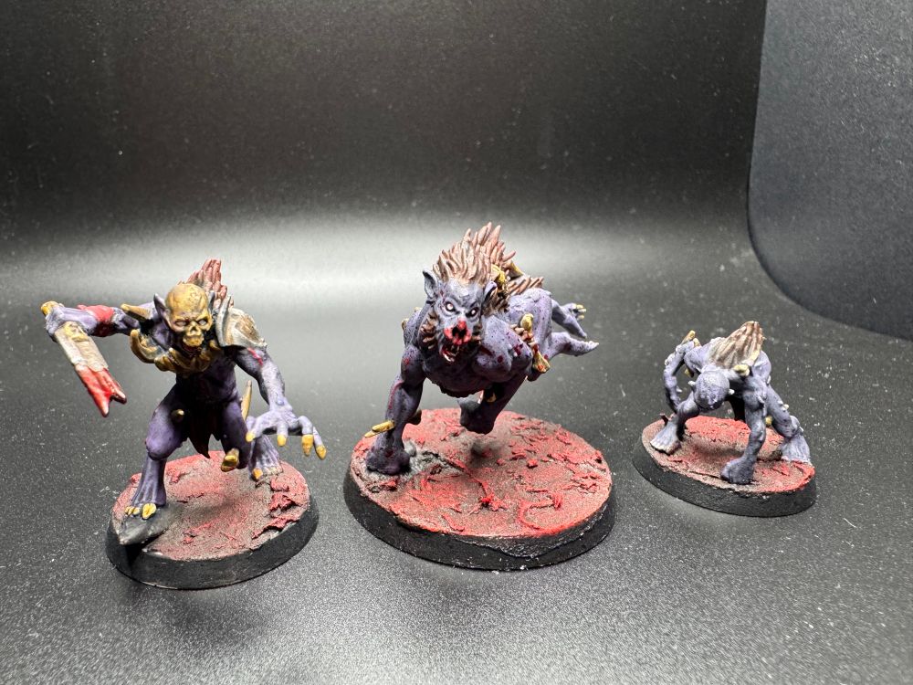 Another trio of a Ghoulgore Squire, Offal Hound, and Ghoul Tracker. They have pale purple skin and are also a bloody mess