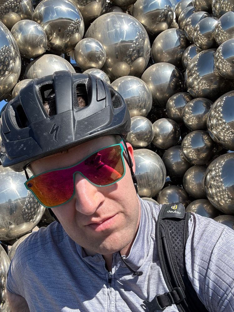 Me in my cycling gear in front of the Talus Dome, a “beloved” Edmonton art installation