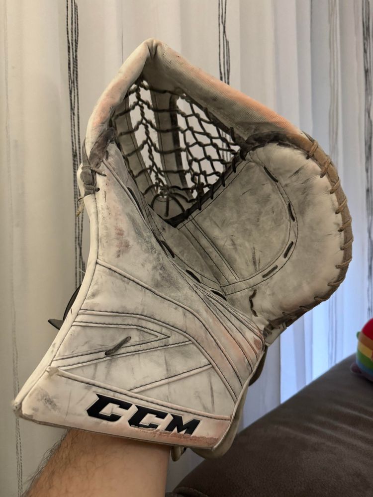 A white CCM ice hockey goalie catcher glove.
Palm view