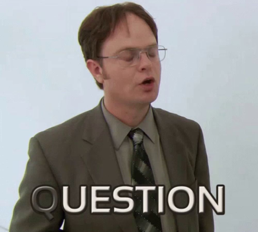 a man in a suit and tie has the word question written on his chest