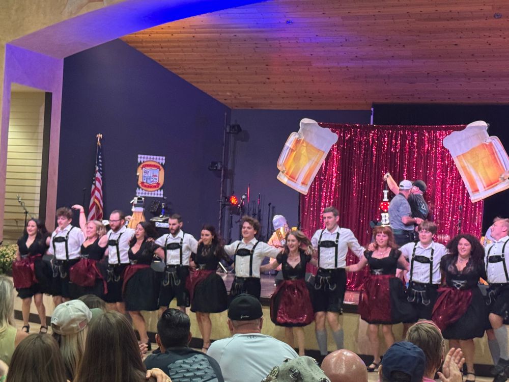 A performance at the Mt Angel Oktoberfest — people in traditional clothing link arms for a dance