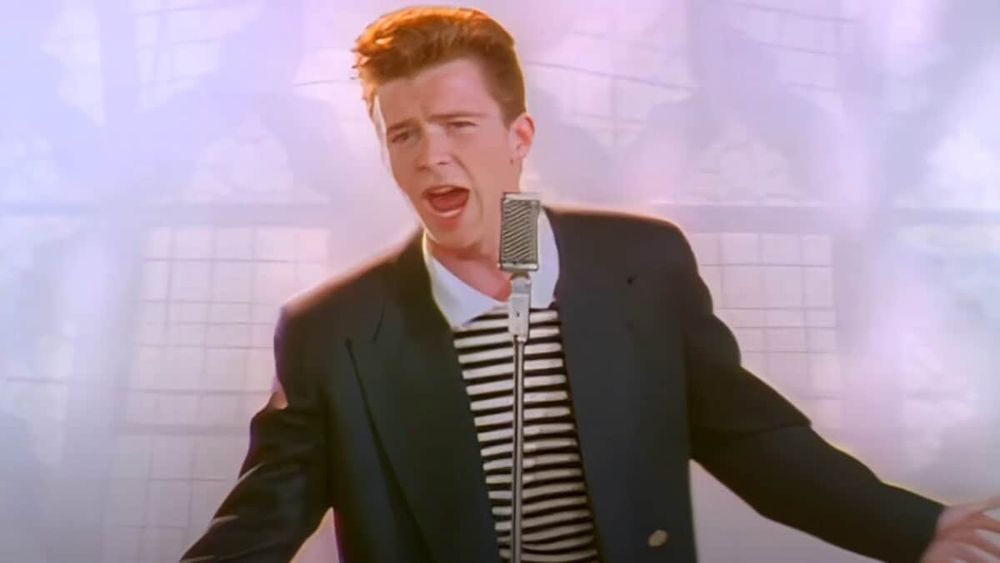 Rick Astley in front of a microphone in the video for "Never Gonna Give You Up"
