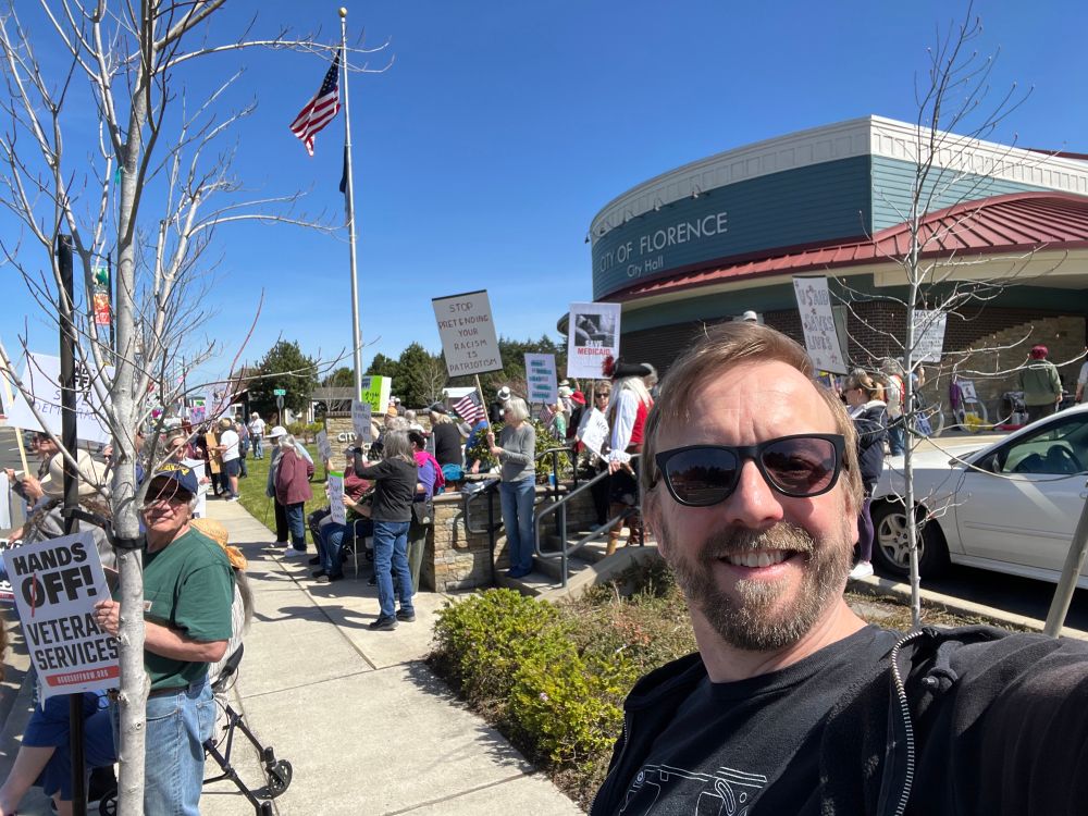 Protestors with signs outside City of Florence town hall in Oregon 