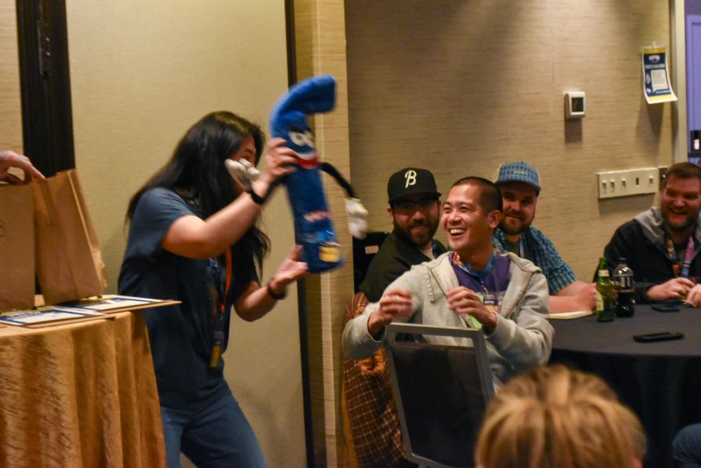 Suzanne holds up Bludle for the audience. 