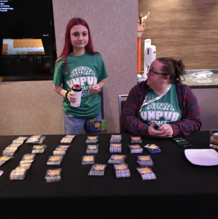 Unpub staff at the registration desk overseeing all the badges