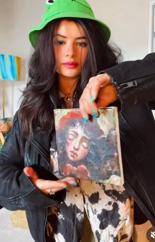 I’m holding a small painting 