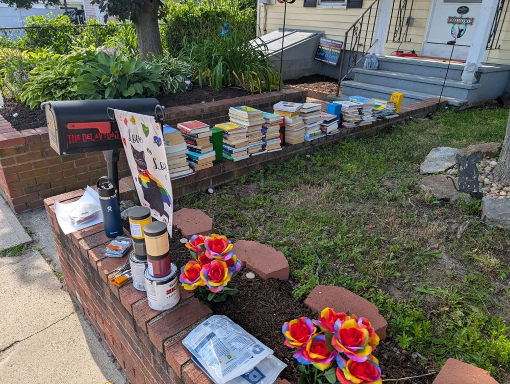 All the books, cleaning and paint supplies on the brick wall of our front yard.